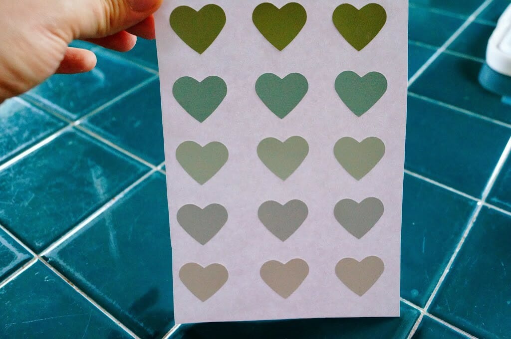 Heart cut-outs glued on paper