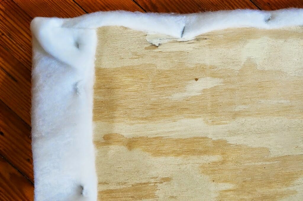 Batting stapled to plywood
