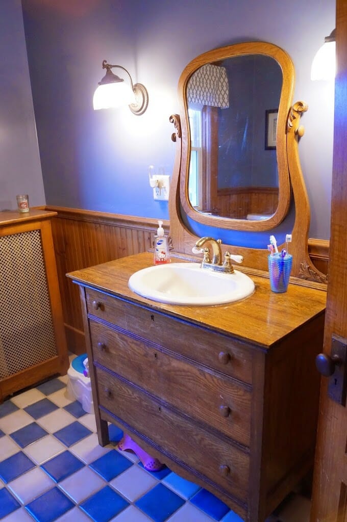 Old fashioned bathroom with tile and dresser turned vanity