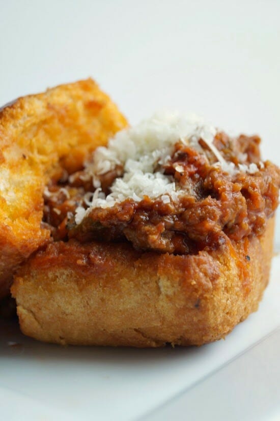 Crockpot Italian Sausage Sloppy Joes slow cooked in the Crockpot, and served over Garlic Bread.
