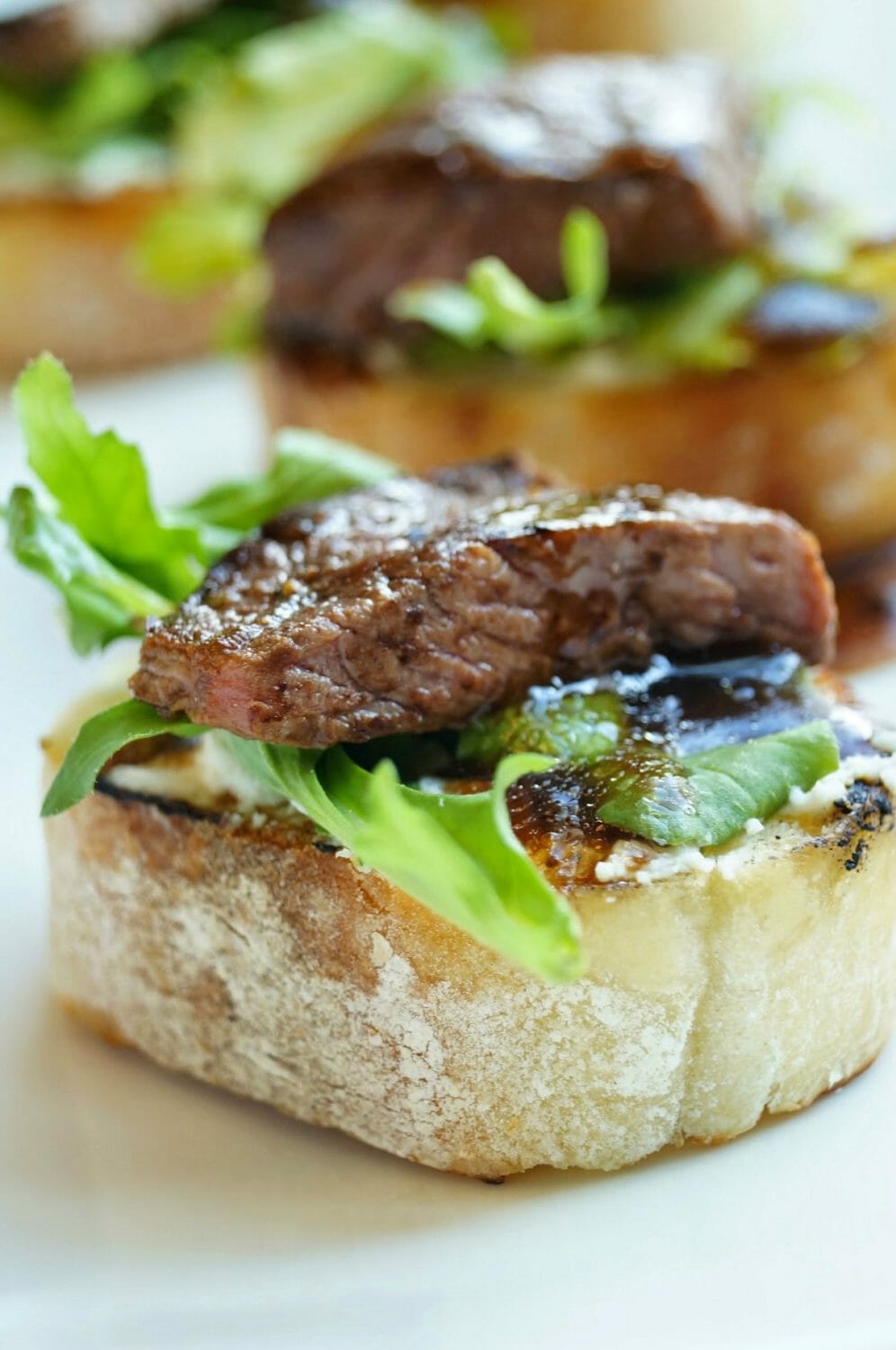 Balsamic Beef Crostini with Herbed Cheese and Arugula 