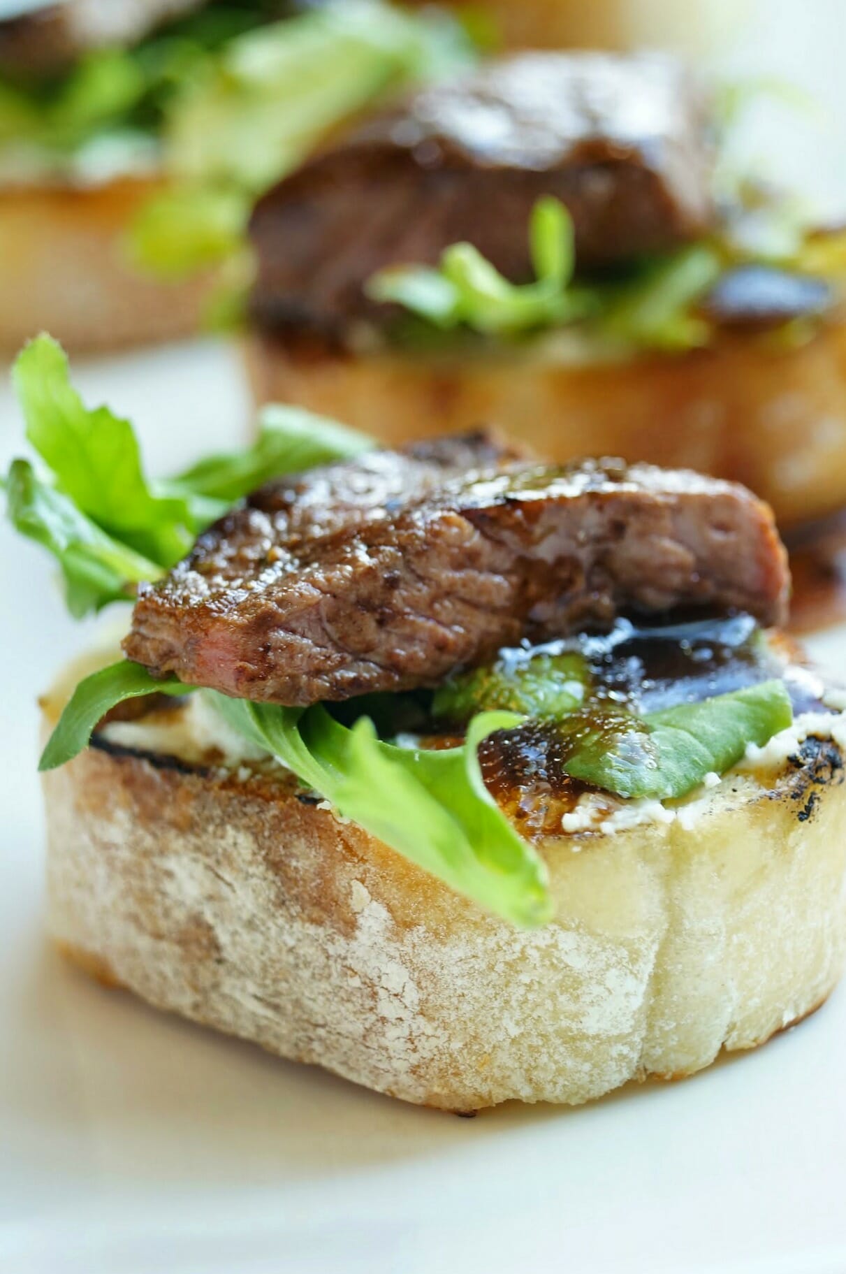 Balsamic Beef Crostini with Herbed Cheese and Arugula