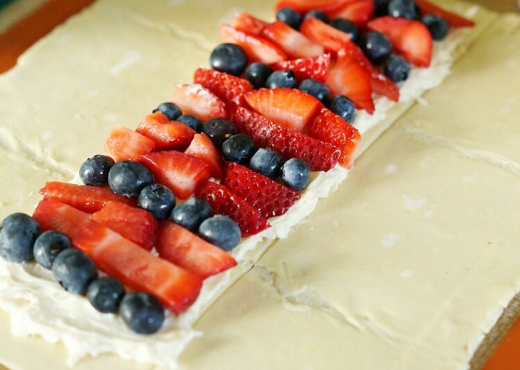 Placing berries and fruit for your summer puff pastry