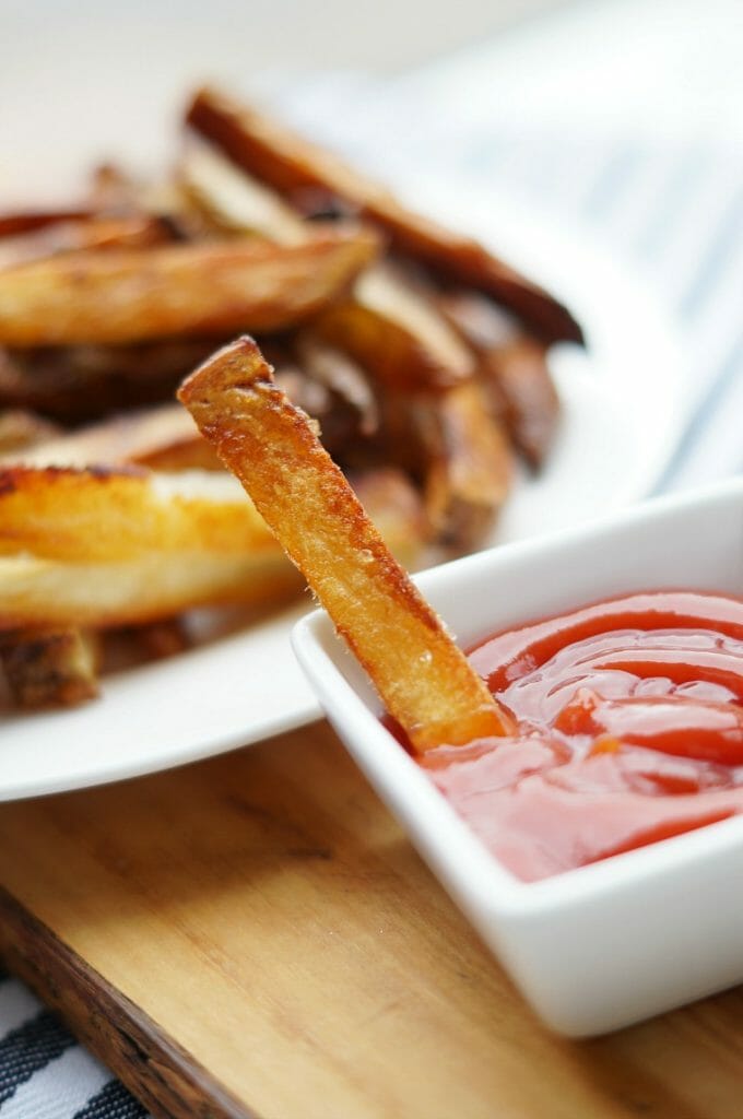 Crispy Baked French Fries dipped in ketchup