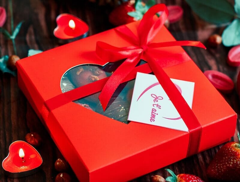 red and white gift box with red ribbon