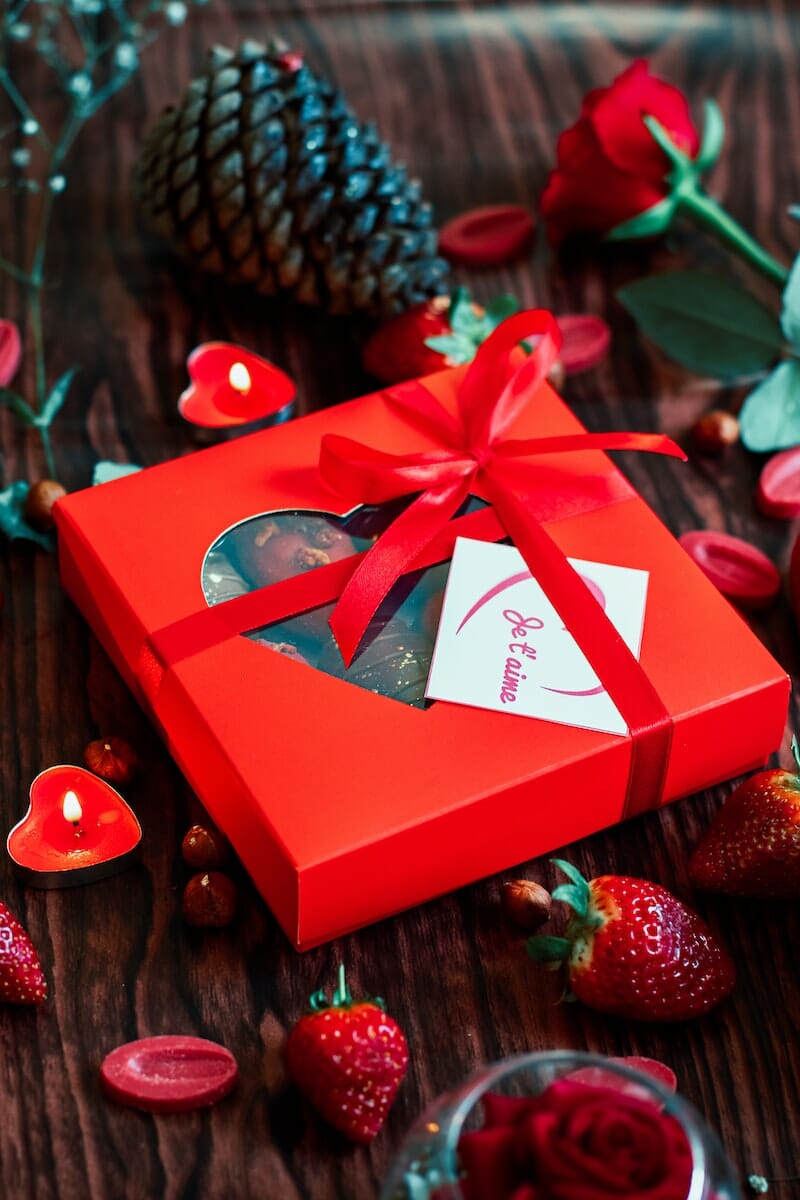 red and white gift box with red ribbon