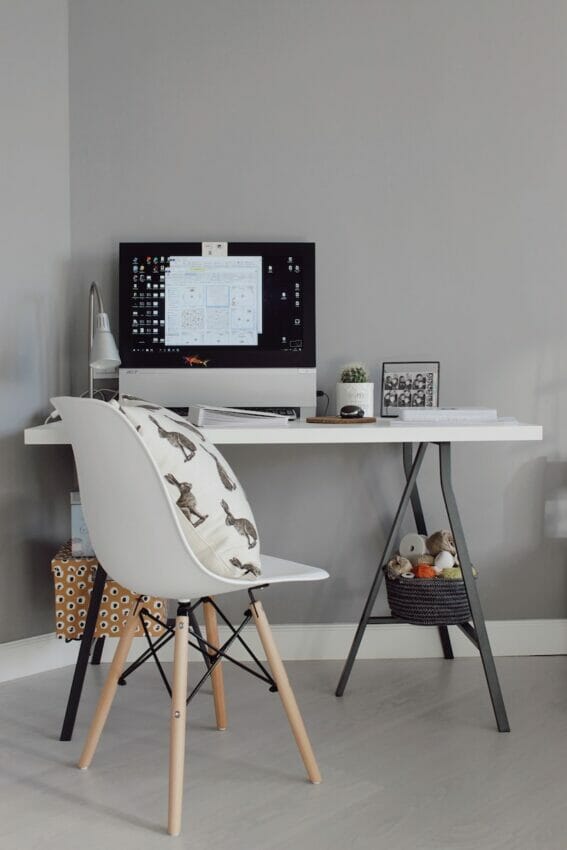 black flat screen computer monitor on white wooden table