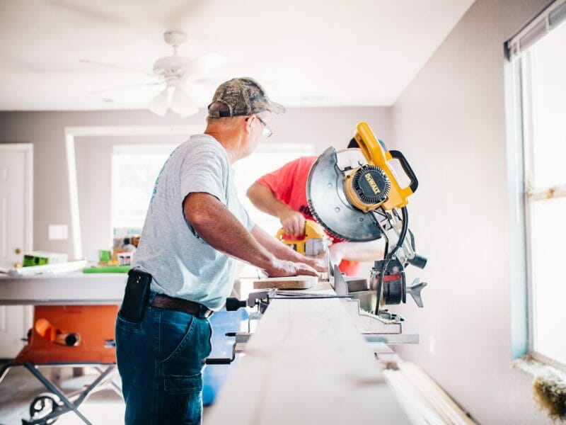 man standing infront of miter saw