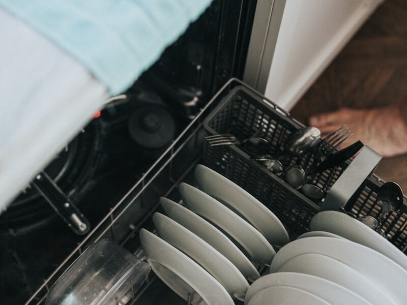 white ceramic plate on black dishwasher