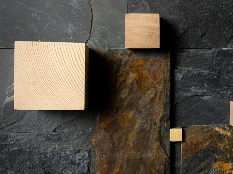 brown wooden chopping board on blue concrete wall