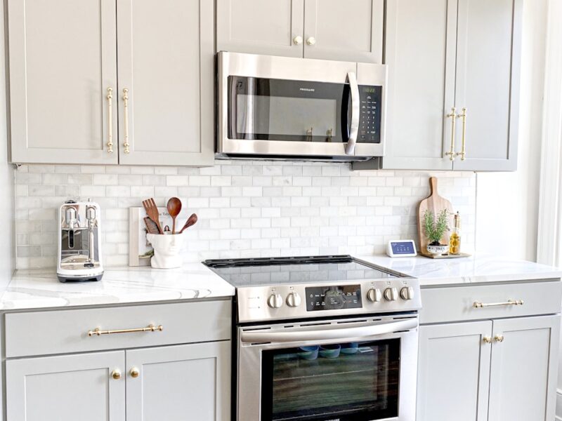 white microwave oven on white wooden cabinet