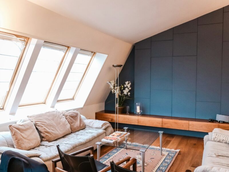 beige 3-seat sofa near the window