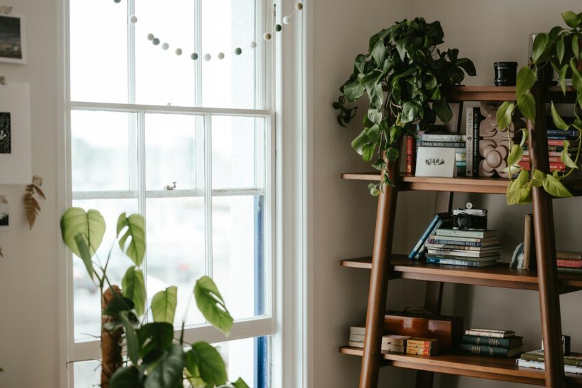 a room with a book shelf and a window