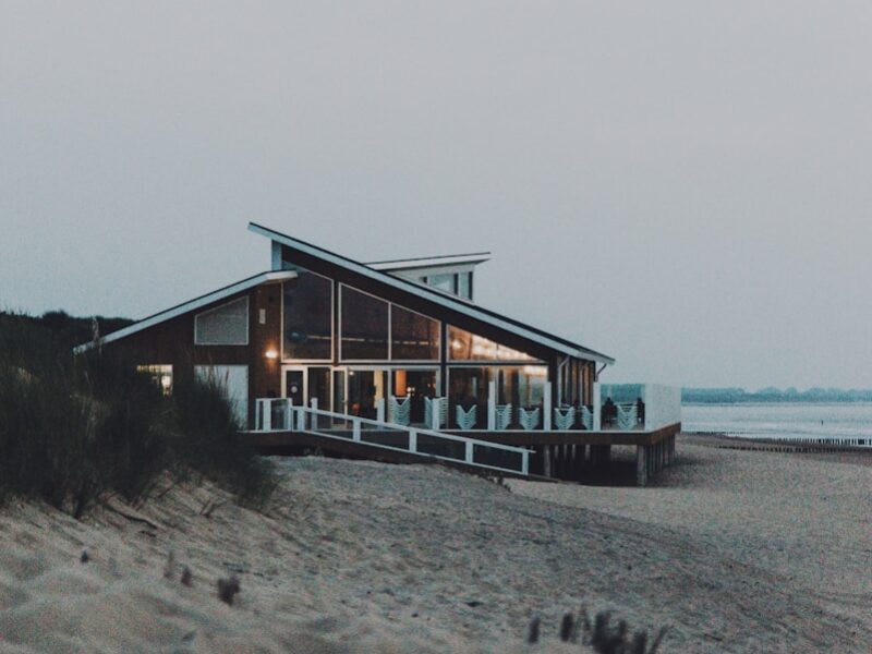 brown wooden house on beach during daytime