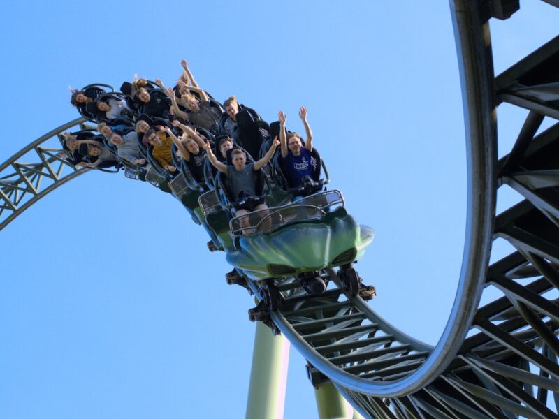 a group of people riding on top of a roller coaster