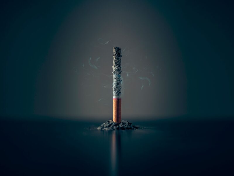 single cigarette stick with ashes stick