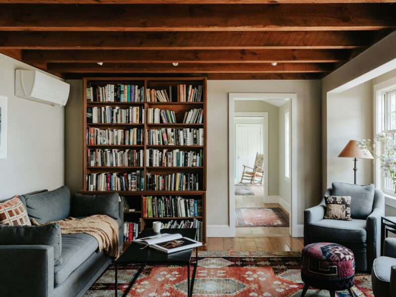 A living room filled with furniture and a book shelf
