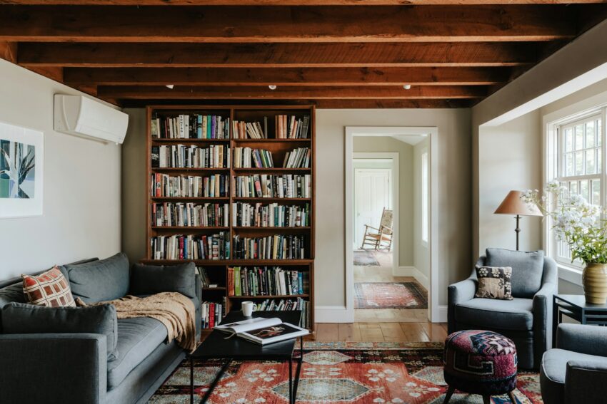 A living room filled with furniture and a book shelf