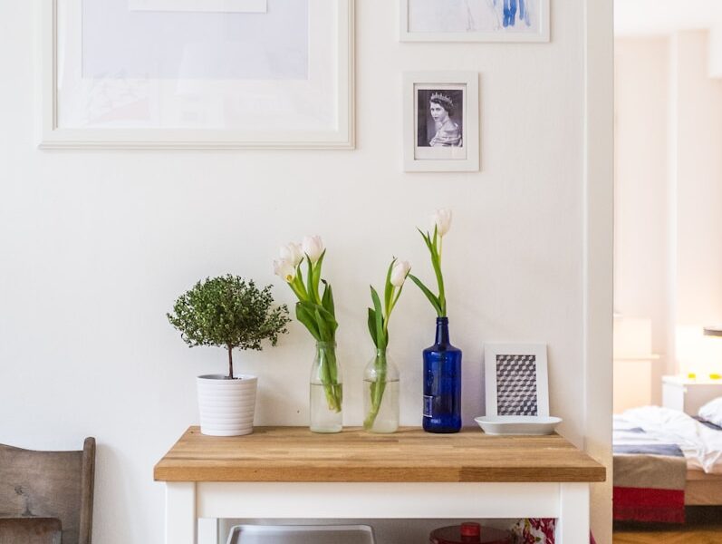white and brown wooden end table near wall inside room