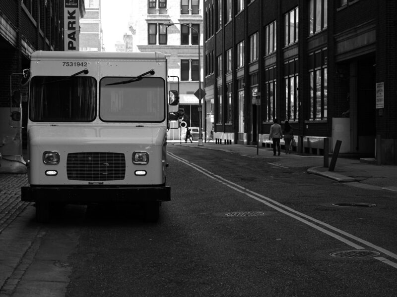 grayscale photo of bus on road