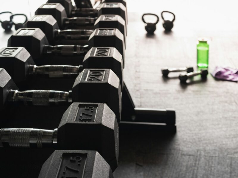 black and gray dumbbells on floor