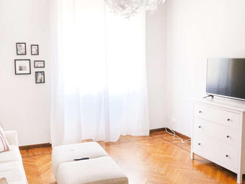 turned-off flat screen television on white dresser