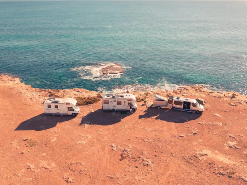 three white RV parks near sea at daytime