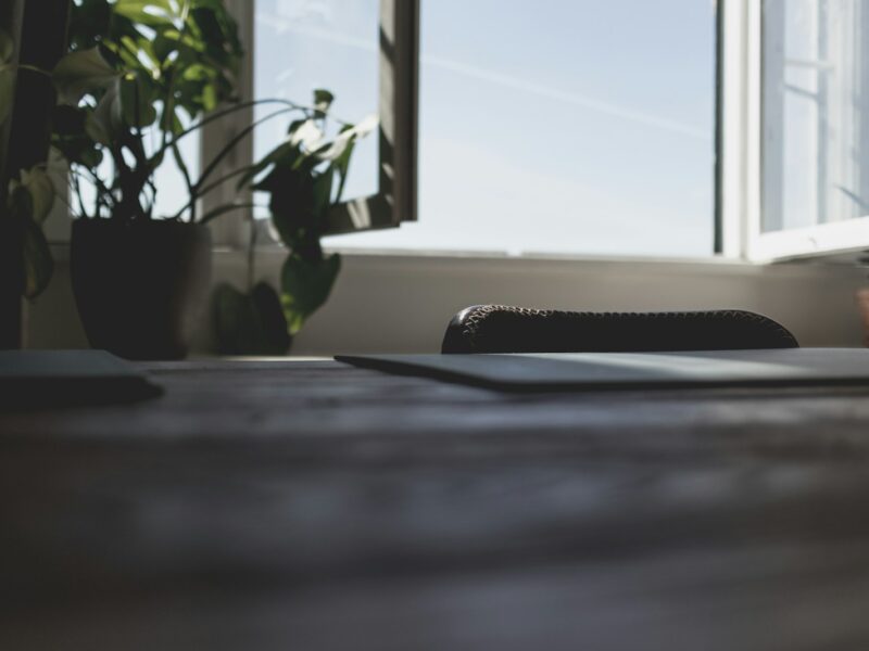 a laptop computer sitting on top of a wooden desk