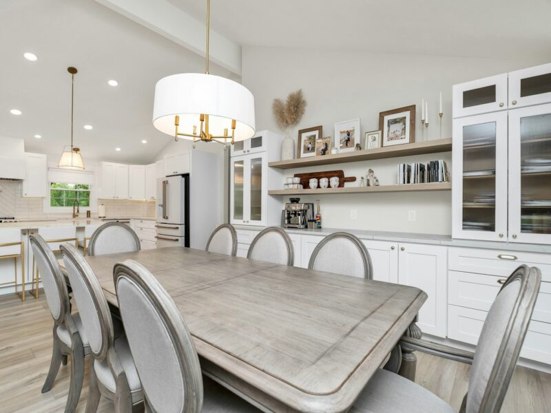 a large kitchen with a table and chairs in it