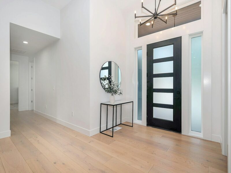 black round wall mirror on white wall