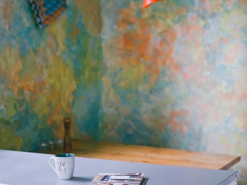 book beside mug on top of dresser