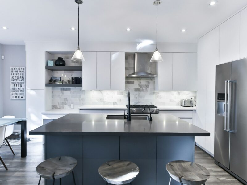 a kitchen with a center island with stools