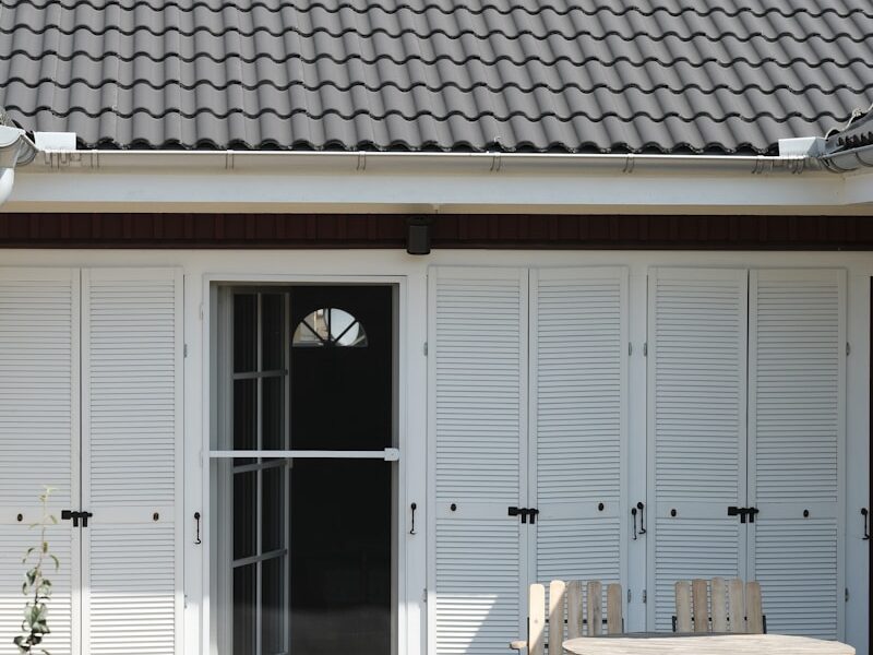 a patio with a table, chairs, and sliding doors