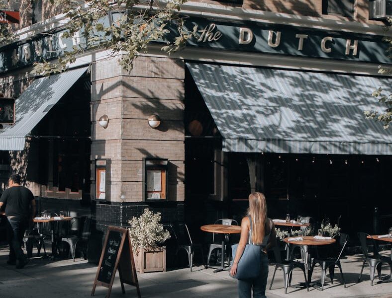 Street view in New York featuring The Dutch restaurant in daylight.