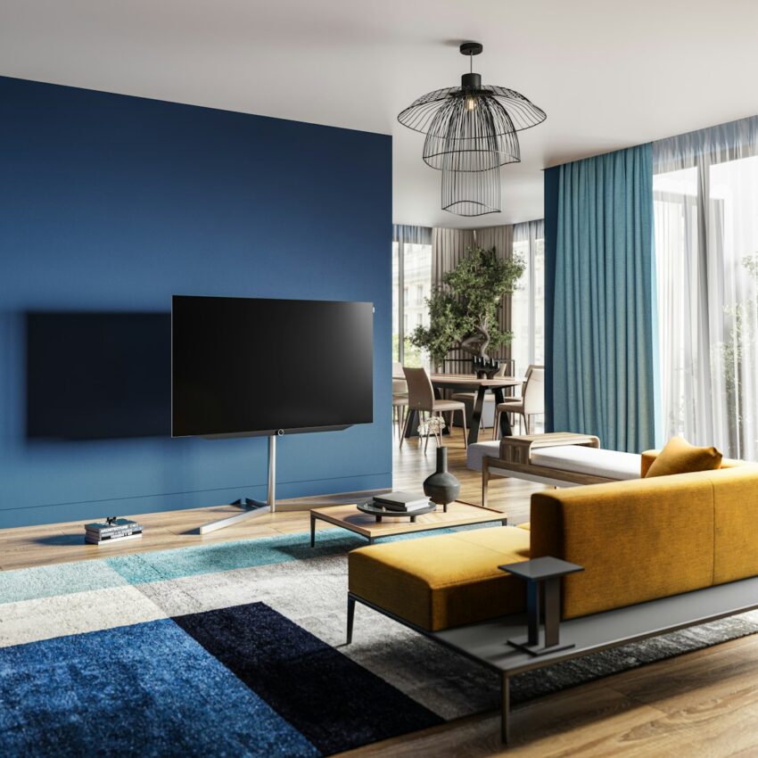 A living room with blue walls and a yellow couch