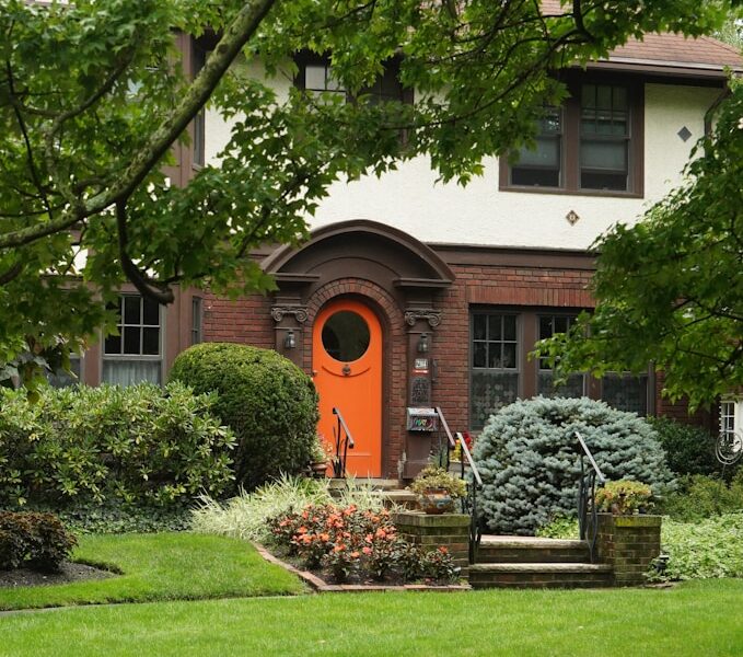 A house with a red door and a green lawn