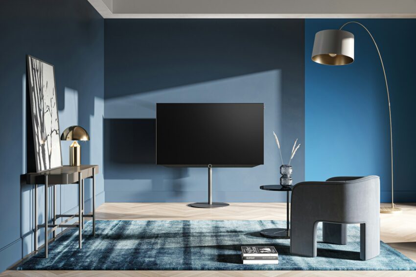 A living room with blue walls and a large flat screen tv