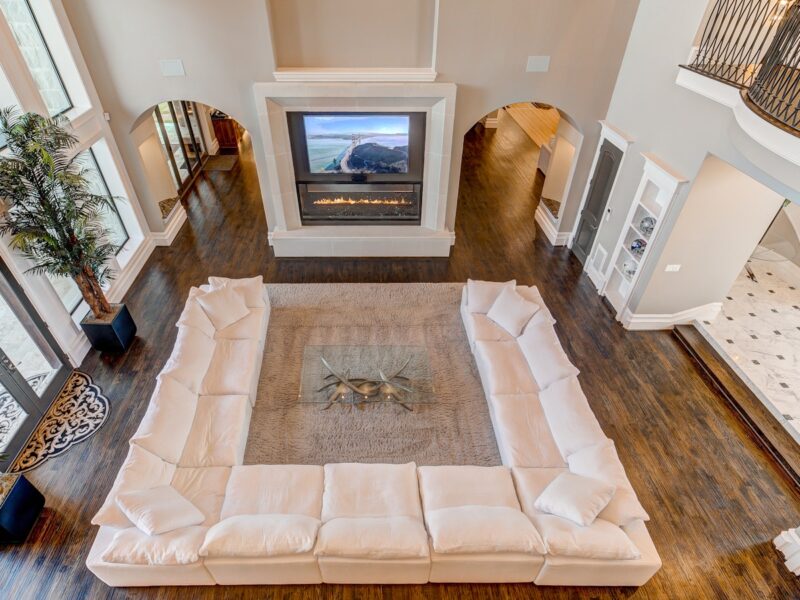 white sectional sofa in front of fireplace inside house