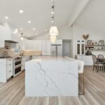 a large kitchen with a center island in the middle of the room