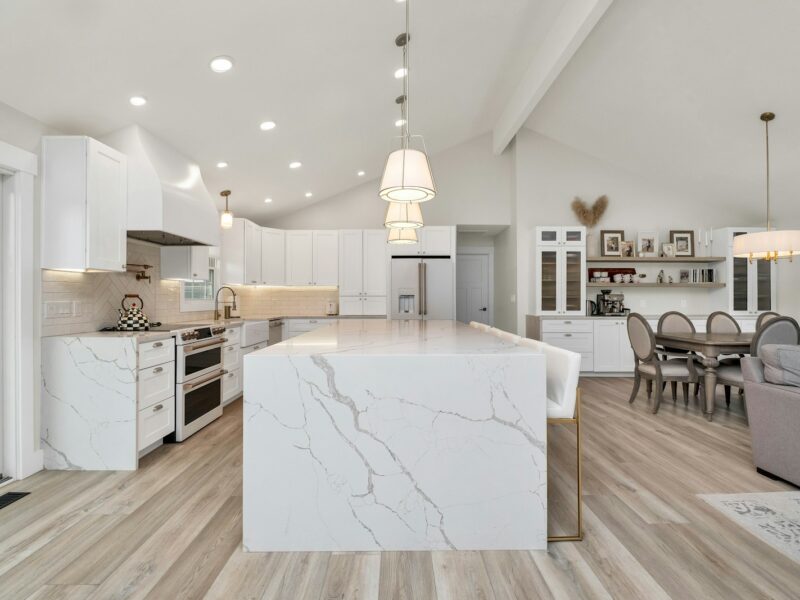 a large kitchen with a center island in the middle of the room
