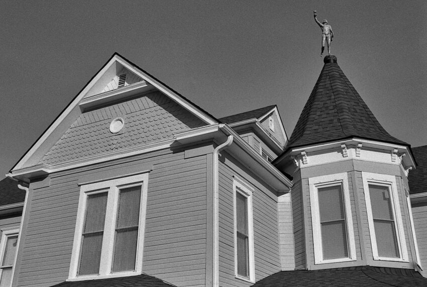a black and white photo of a house with a steeple