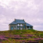 white and gray house under cloudy sky