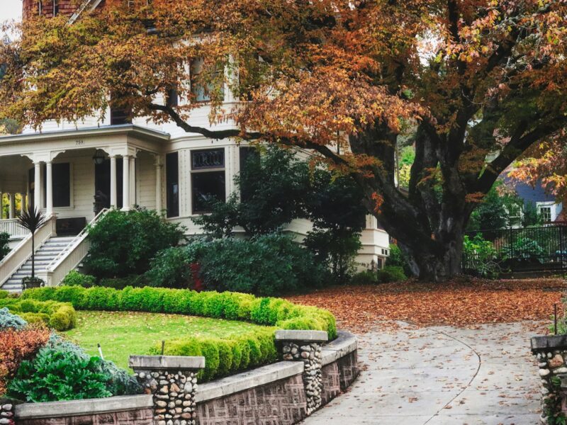 A large white house with a garden in front of it