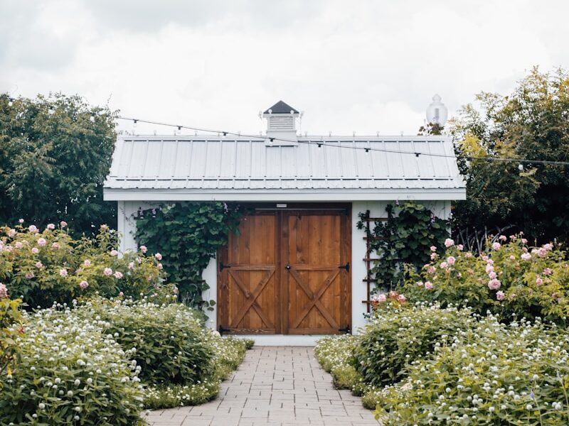 closed brown wooden door under cloudy sky during daytime
