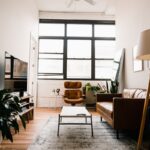 brown wooden table with chairs near window