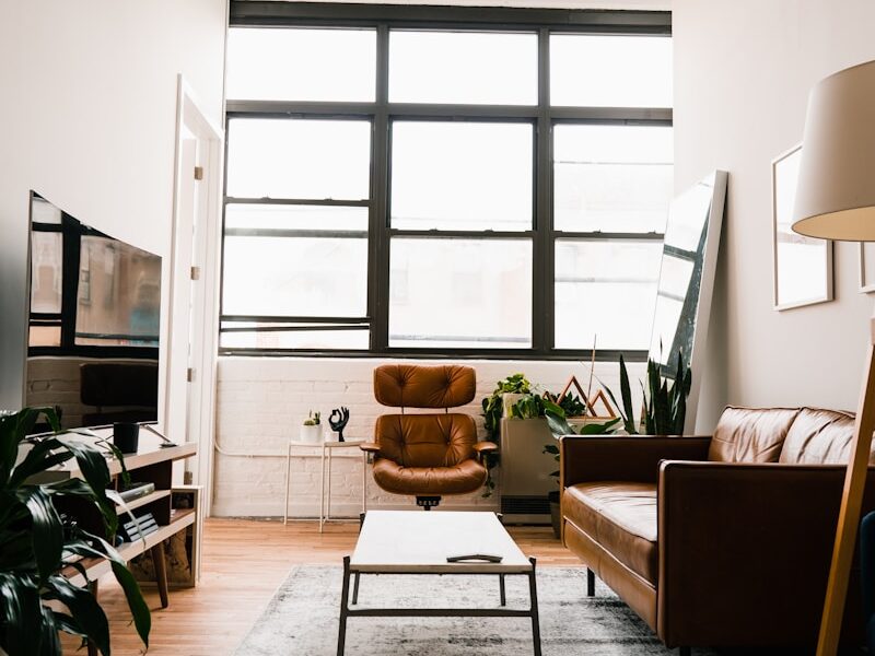 brown wooden table with chairs near window