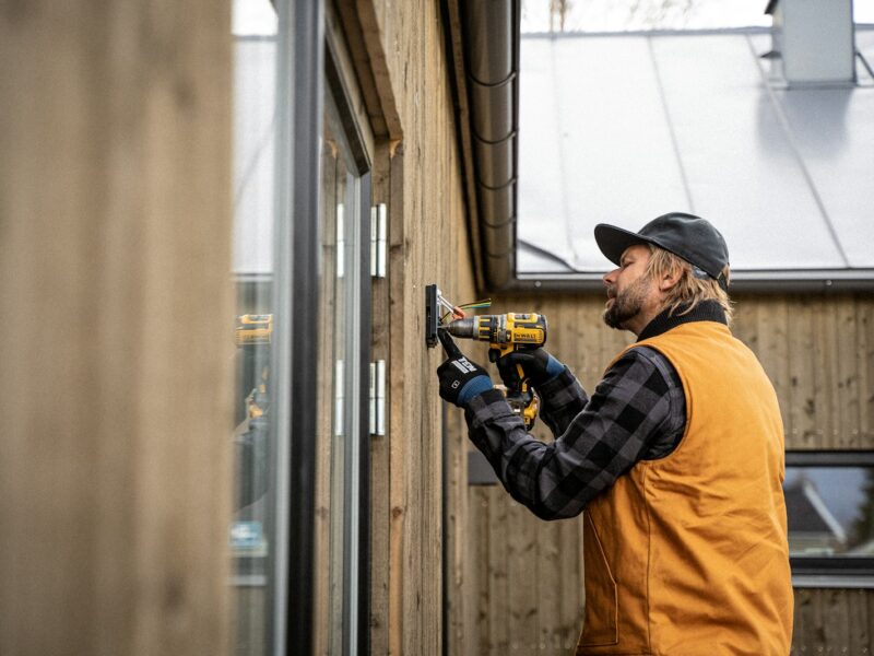 a man with a driller and a hat on