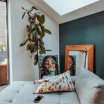 a living room with a couch and a potted plant