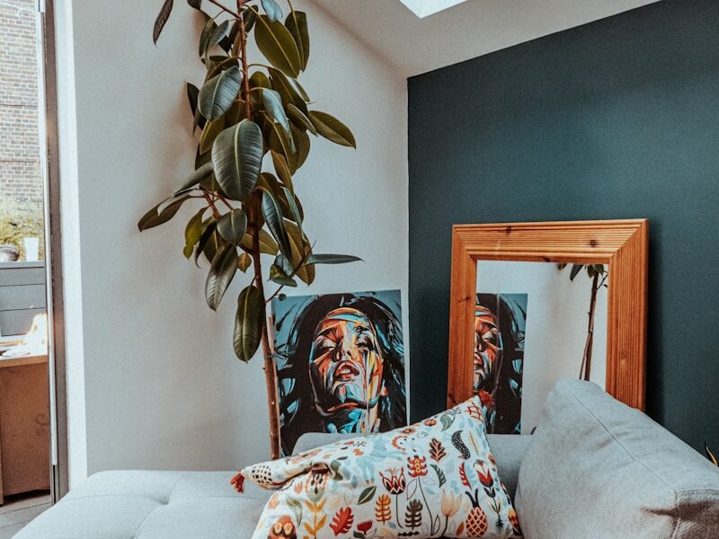 a living room with a couch and a potted plant