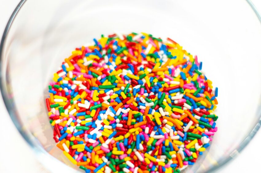 a glass bowl filled with sprinkles on top of a table
